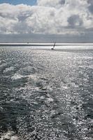 Zon over de Waddenzee met zeilboot