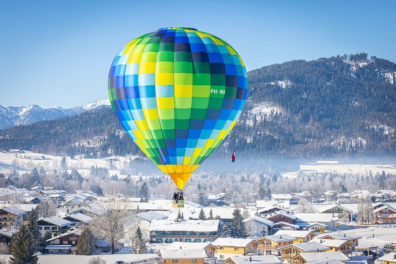Hot air balloons adorn the sky over a snowy Inzell in Germany by Stefan Verkerk fotografie