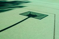 Basketball shadows on a green court