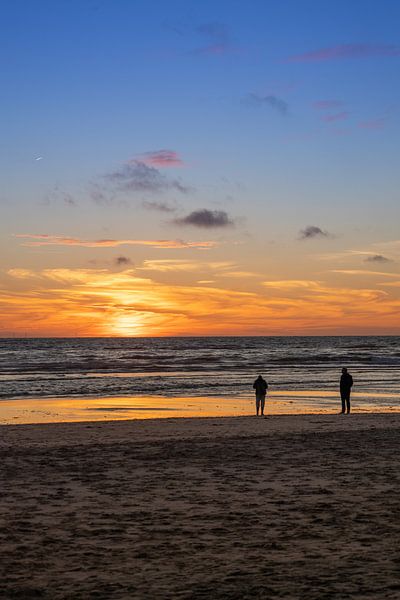 Couple on beach in evening by Michael Ruland