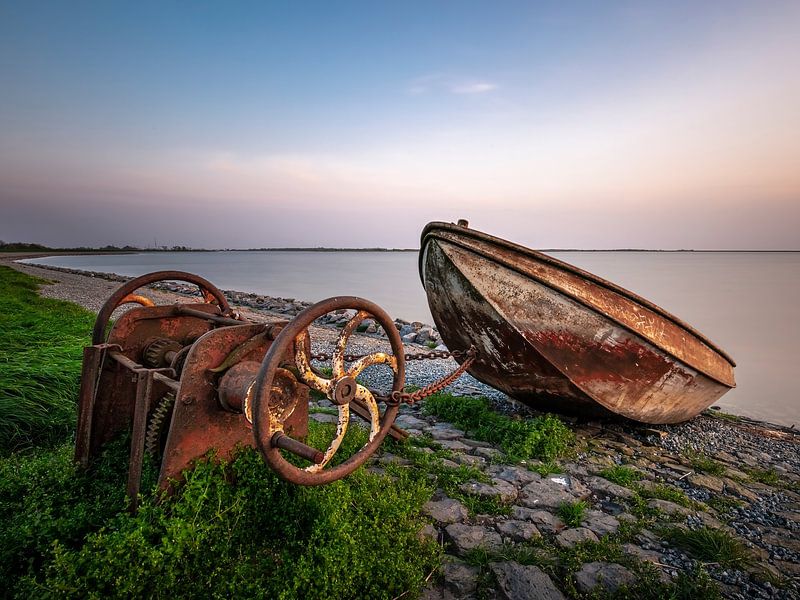 Weathered boat and rusty winch on shore by ThomasVaer | Tom Coehoorn