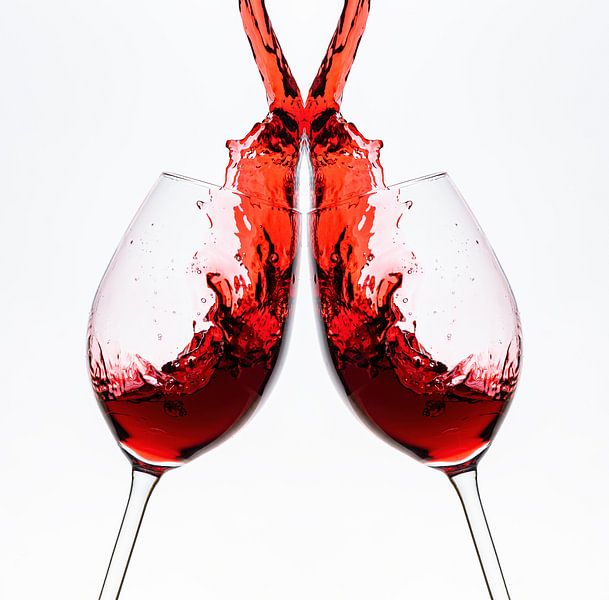 Red wine flows into the wine glass by Roland Brack