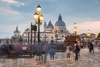 Venice in eveninglight with moving people