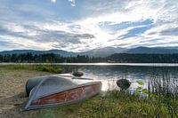 Mountain lake with characteristic rowing boat on the shore