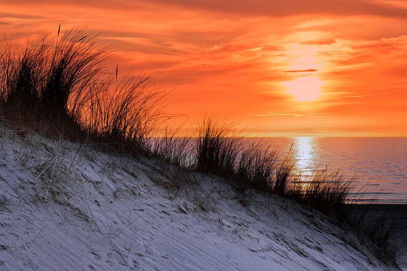 Orange sky at sunset with sea shore coast and dune by Ben Schonewille