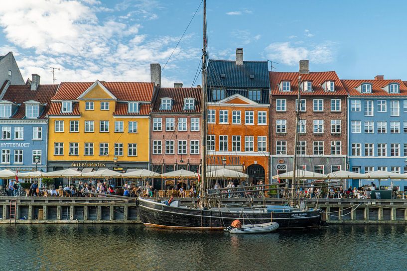 Old sailboat on colorful street in Copenhagen by Axel Weidner