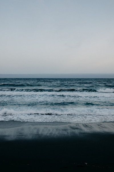 Black beach, blue sea and white waves in Tenerife by Yvette Baur