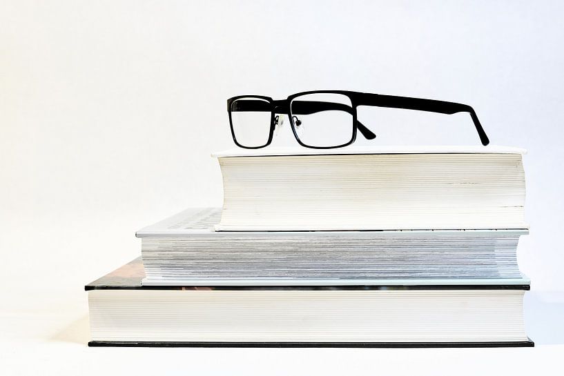 three thick books with glasses by Heiko Kueverling