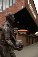Statue de Leo Halle avec la tribune de Leo Halle à l'arrière-plan.
