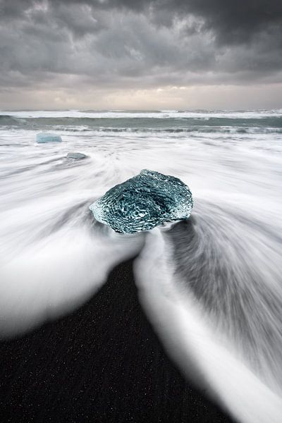 Block of ice on black beach by Ralf Lehmann