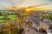 autumn morning seen over the Jeker valley and Chateau Neercanne with rising sun harps