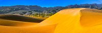 Gran Canaria with dunes near Maspalomas and view to the mountains.