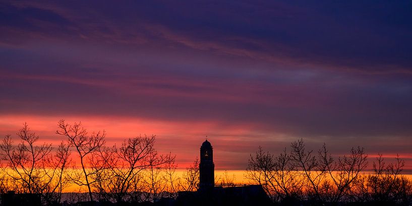 Sun behind the clouds in the sky during sunset over Zwolle by Sjoerd van der Wal Photography