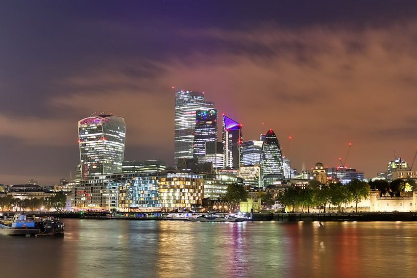 Night image of London skyline with reflections on the Thames - business district with many colorful  by MPfoto71