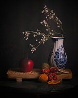Delft blue vase with white flowers and dried fruit