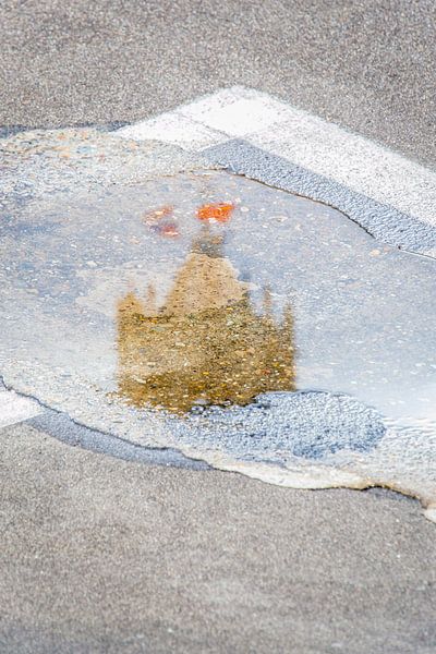 De top van de Domtoren in Utrecht weerspiegeld in een plas. by Margreet van Beusichem